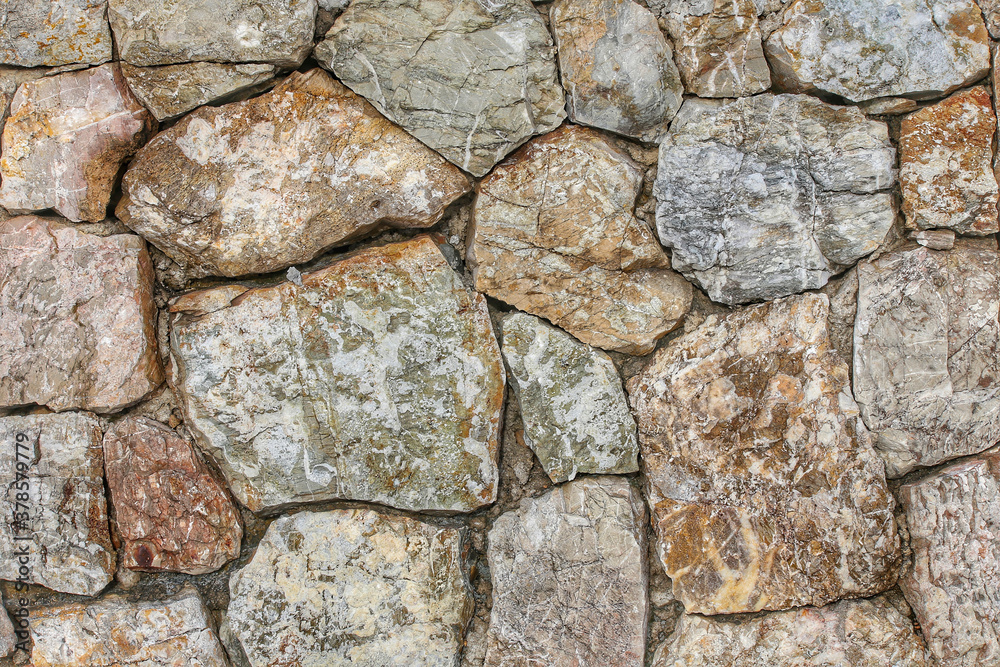 Rock wall was made from many big rocks, stone wall texture background, pattern stone style design decorative real stone wall surface with cement. Rock wall was made from many big rocks, stone wall texture background, pattern stone style design decorative real stone wall surface with cement.