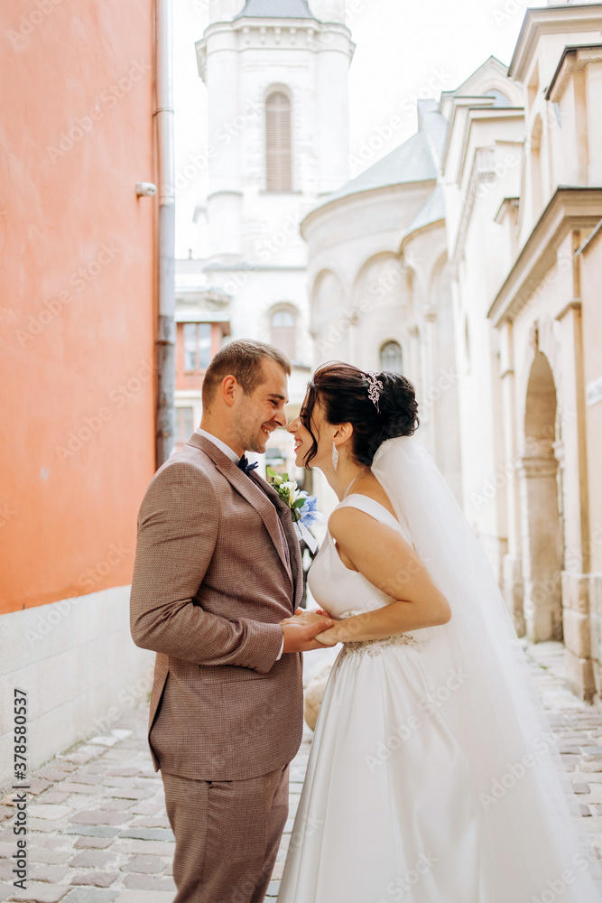 Happy young couple kissing on the background of old buildings. Happy young couple kissing on the background of old buildings.