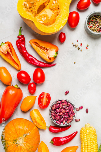 Fresh Red Vegetables. Pumpkin, Pepper and Tomatoes on a gray background