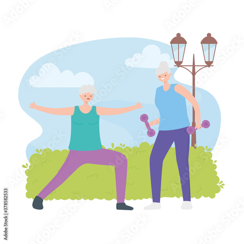 activity seniors  portrait of aged women doing exercise with dumbbells on nature