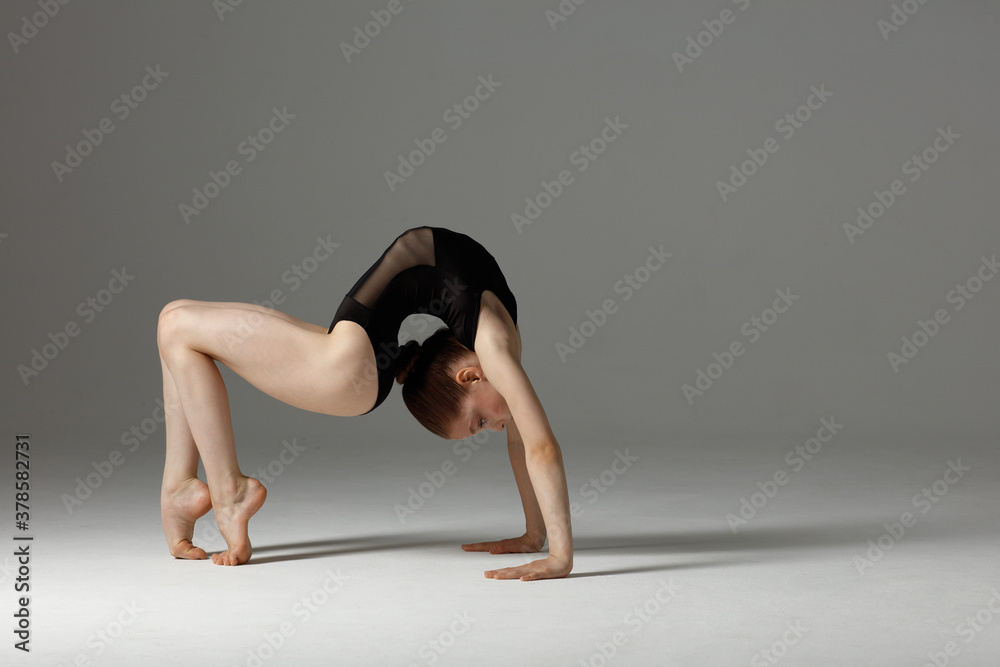 Young gymnast girl stretching and training Stock Photo