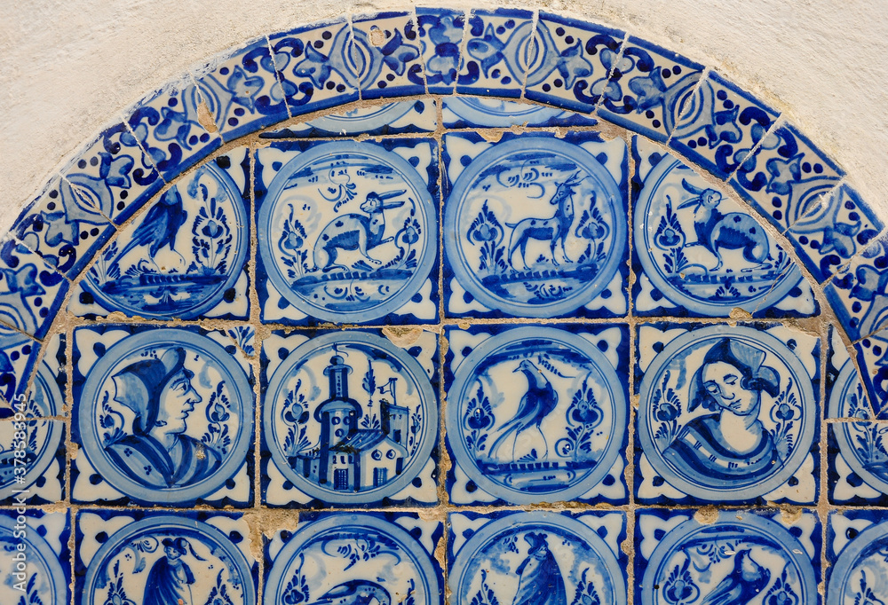 Typical Andalusian azulejos (blue ceramic tiles) with animals and people