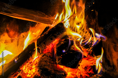 Romantic bright open fire on wood in hut in Norway. photo