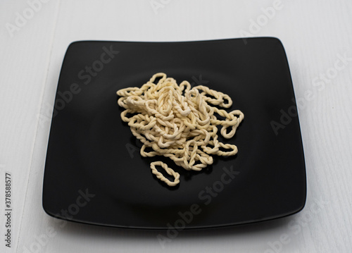 Lorighittas, an ancient pasta of the Sardinian tradition. the term lorighittas means rings or earrings. It is made of refined fine spaghetti and woven exclusively by hand. Only semolina and water

 photo