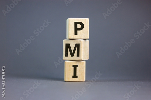 Wood cubes with word 'PMI' stacking as stack on beautiful grey background, copy space. Business concept.