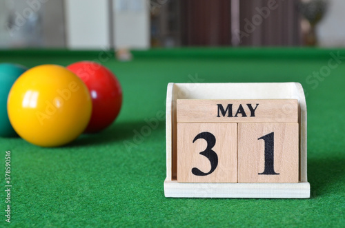 May 31, number cube with balls on snooker table, sport background. photo