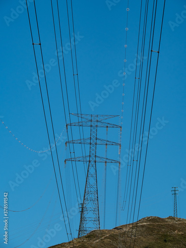 high tension metal towers in the mountain area