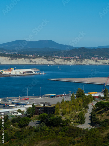 port of bilbao with ships and containers. you can see some industry and the sea as well as boats