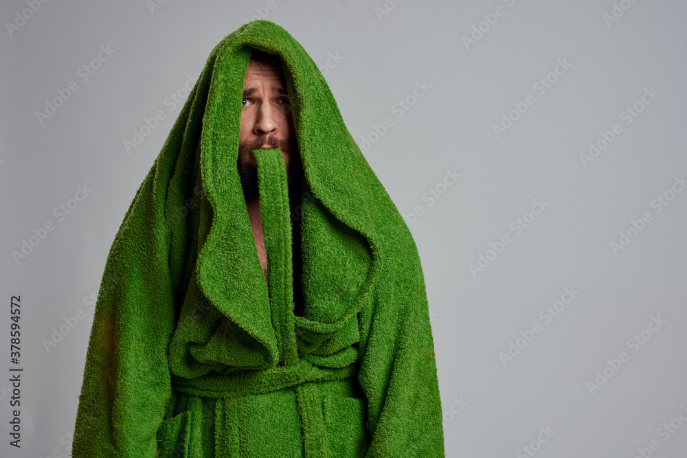 Bearded man in green robe cropped view gray background close-up Bearded man in green robe cropped view gray background close-up