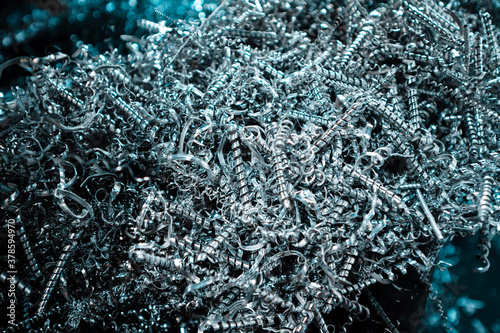 A pile of metal spirals as burr waste in metal processing.