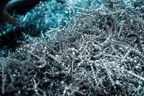 A pile of metal spirals as burr waste in metal processing.