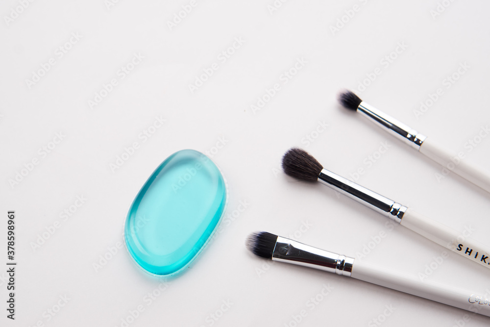 Professional makeup brushes and light background transparent drop of soap cosmetics Professional makeup brushes and light background transparent drop of soap cosmetics