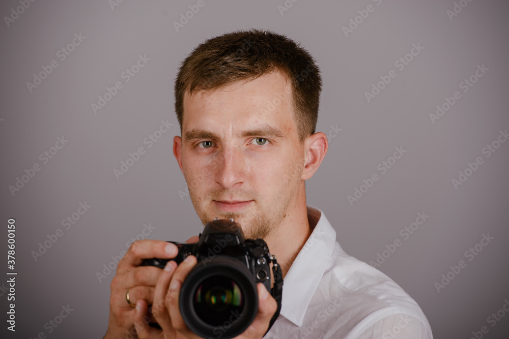 Fototapeta premium Young man using a professional camera