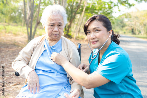 Doctor using stethoscope to checking the patient in park, healthy strong medical concept
