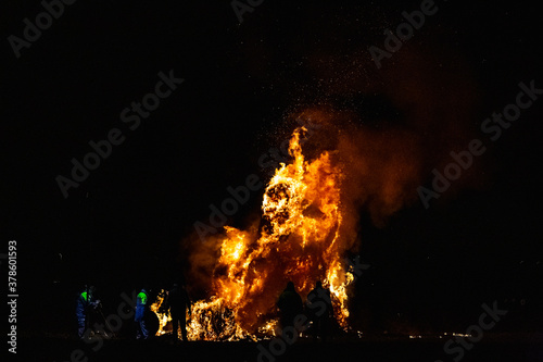 Ancient tradition of Epiphany fires in Friuli, Italy. Burning of a straw effigy. Farewell to winter, arrival of spring