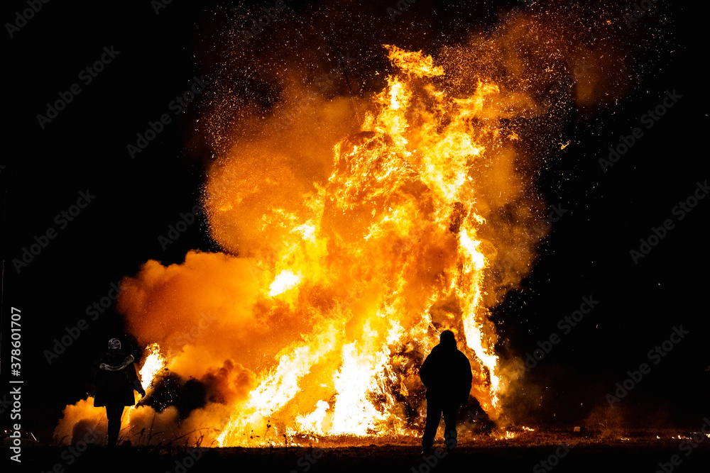 Ancient tradition of Epiphany fires in Friuli, Italy. Burning of a straw effigy. Farewell to winter, arrival of spring Ancient tradition of Epiphany fires in Friuli, Italy. Burning of a straw effigy. Farewell to winter, arrival of spring