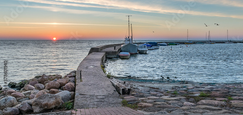 Sunrise at fishing port and pier in resort city of Nida, Lithuania, Europe