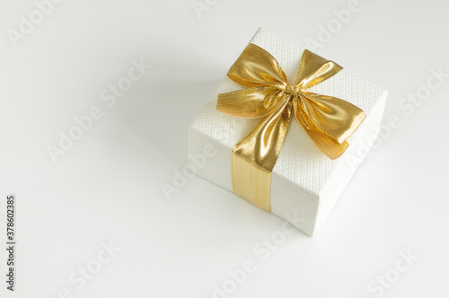 Gift box with gold ribbon. Place for your text. Selective focus