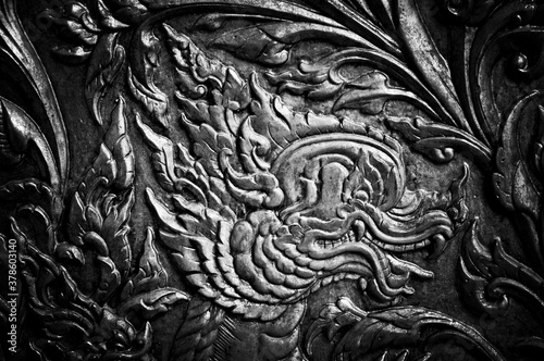 Closeup Beautiful Thai pattern carving lotus picture at door in temple.