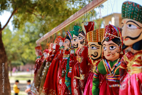 Fotografie Colorful human face shaped Puppets wearing colorful clothes hanging against the
