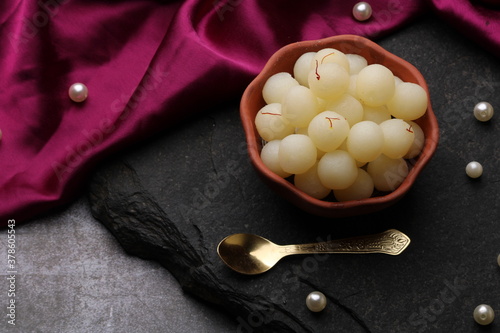 Indian Sweet Rasgulla Also Know as Rosogolla, Roshogolla, Rasagola, Ras Gulla, Anguri Rasgulla or Angoori Rasgulla is a Syrupy Dessert Popular in India. It is Madeup with milk. photo