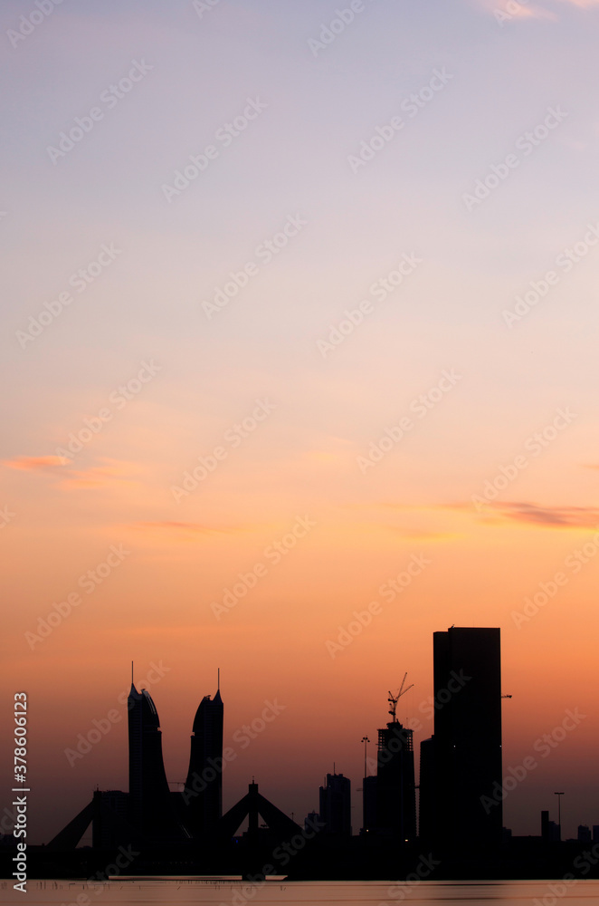 Bahrain skyline with iconic buildings at dusk with dramatic hue in sky