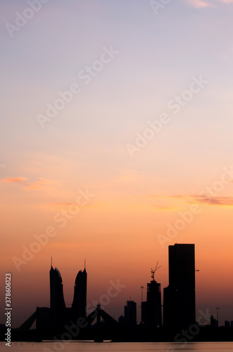 Bahrain skyline with iconic buildings at dusk with dramatic hue in sky