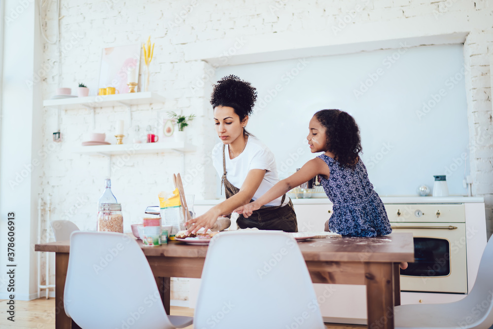 Black mother taking cookie for daughter Black mother taking cookie for daughter