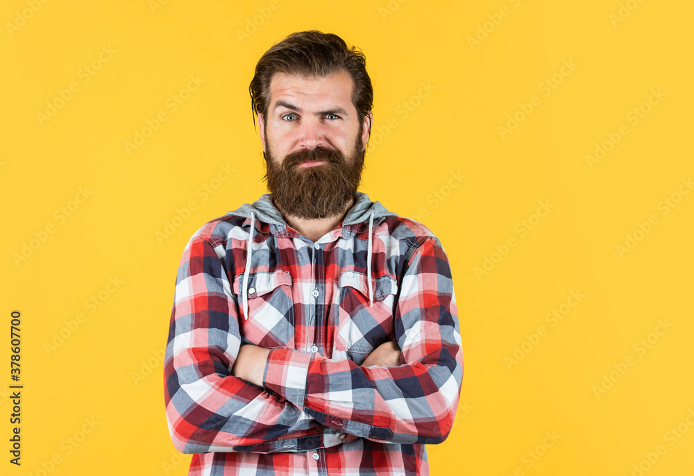 Facial care. portrait of handsome bearded man in plaid shirt. man wearing casual clothes. brutal serious man with beard standing indoor. Young and brutal. Confident and handsome brutal man Facial care. portrait of handsome bearded man in plaid shirt. man wearing casual clothes. brutal serious man with beard standing indoor. Young and brutal. Confident and handsome brutal man