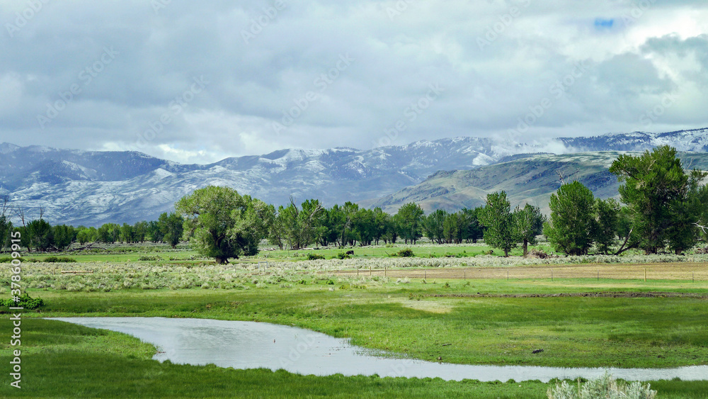 beautiful mountains covered in clouds with a river in the landscape 