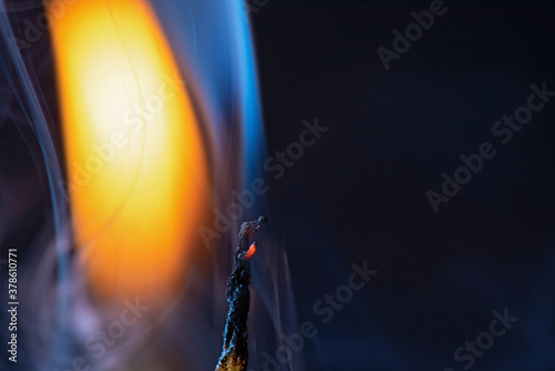 Smoke from an extinguished candle on a dark background.