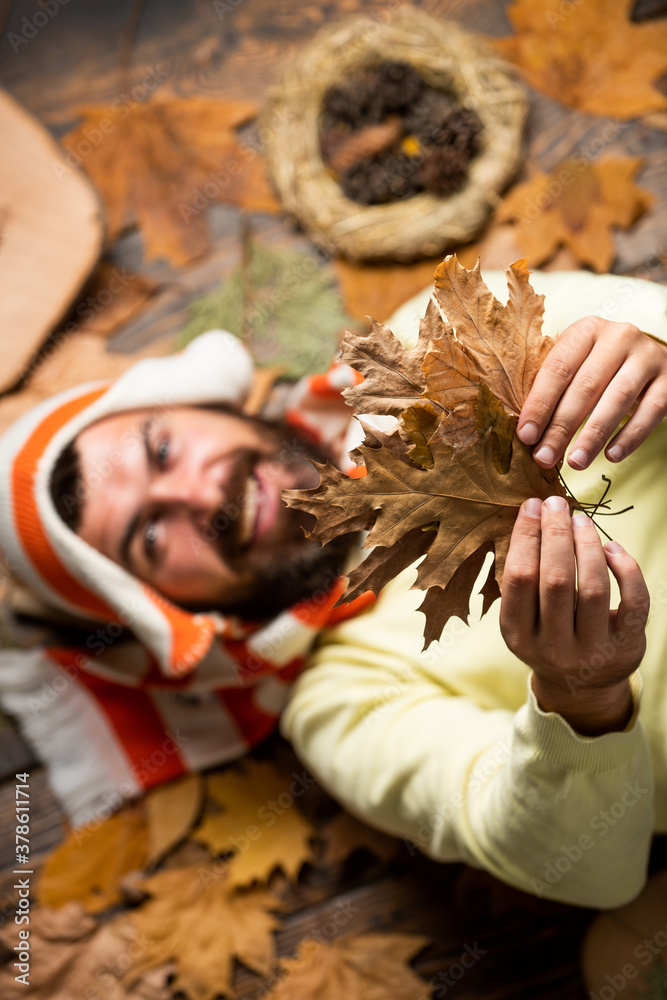 Follow me. autumn male fashion. Carefree and happy. man hold maple leaf. canada. hipster relax on autumn background. handsome in autumn style. human in nature. Staying cheerful any season