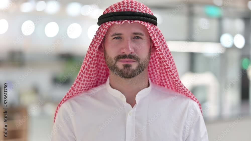Serious Arab Businessman Putting Finger on Lips 