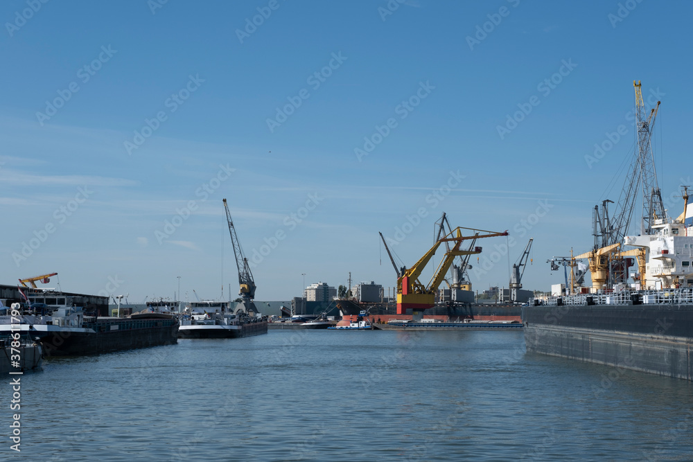 Logistics and transportation of Container Cargo ship and Cargo plane with working crane bridge in shipyard