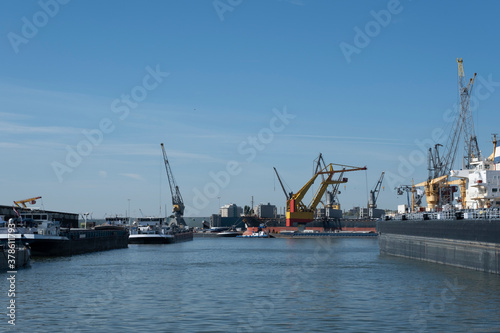 Logistics and transportation of Container Cargo ship and Cargo plane with working crane bridge in shipyard