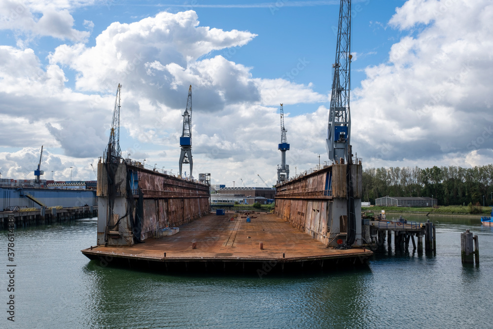 Rotterdam, The Netherlands Eye level view on an empty floating dry dock with large cranes on the side