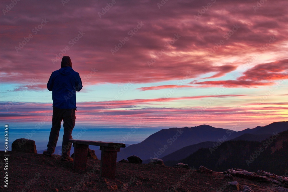 Man watches colorful sky