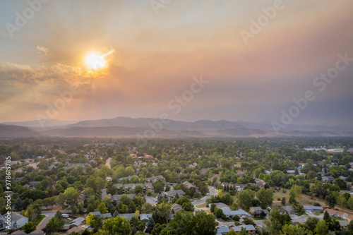 wildfire smoke from Cameron Peak Fire (September 2020) over Fort Collins and Front Range of Rocky Mountains in northern Colorado, aerial view