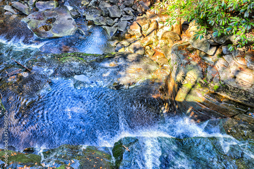 Elakala waterfall in Blackwater Falls State Park in West Virginia during autumn with blue vibrant water flat top view down from bridge photo