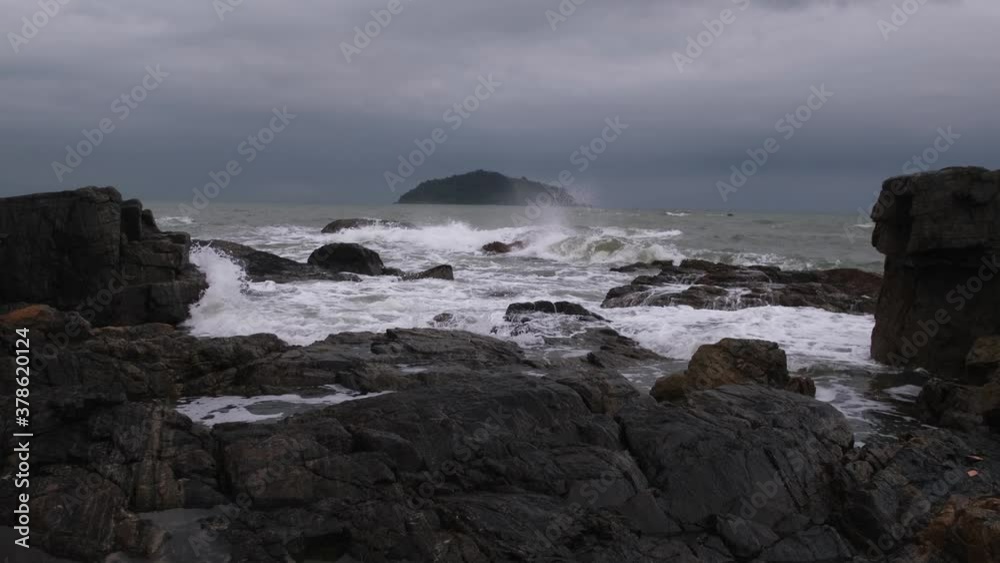 waves crashing on rocks and island waves crashing on rocks and island