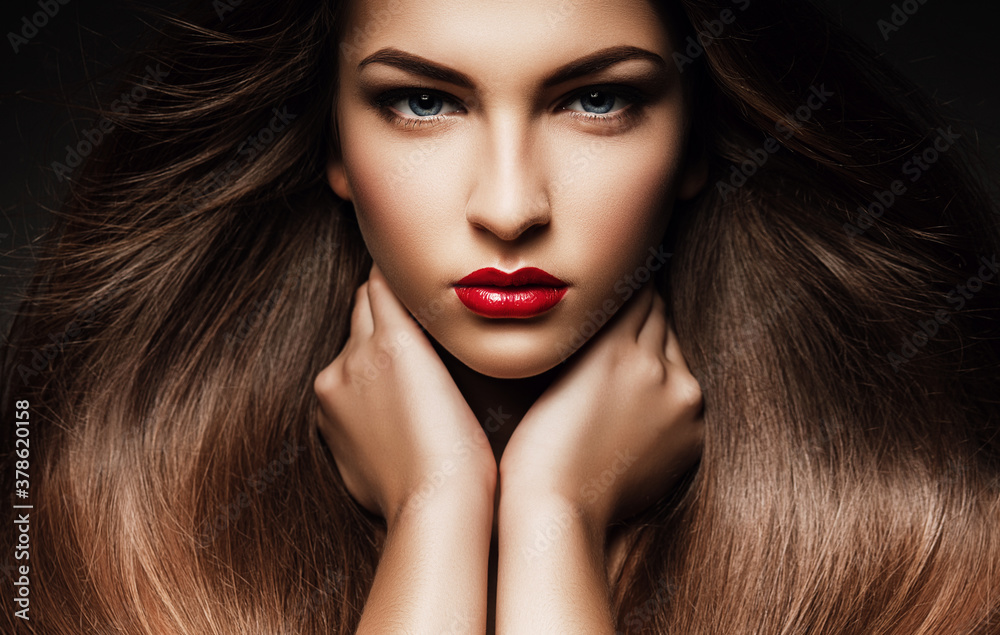 Fototapeta premium Beautiful woman with long hair and red lips