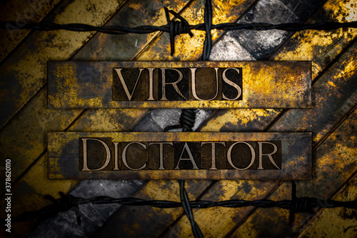 Virus Dictator text formed with real authentic typeset letters with barbed wire on vintage textured silver grunge copper and gold background