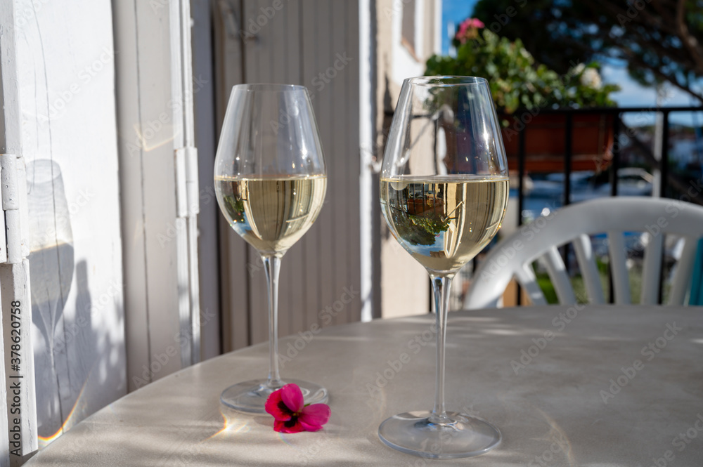 Tasting of local white wine on sunny summer balcony Provence, France Tasting of local white wine on sunny summer balcony Provence, France