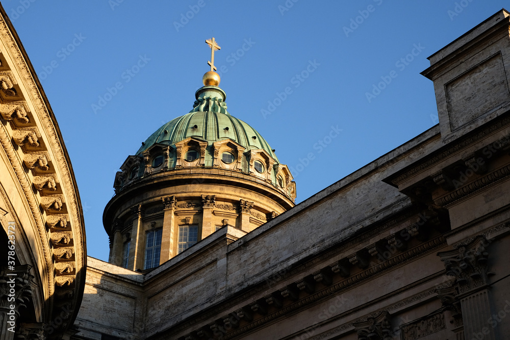 Roof dome with cross of Kazan Cathedral in St. Petersburg, Russia on blue sky and sunlight