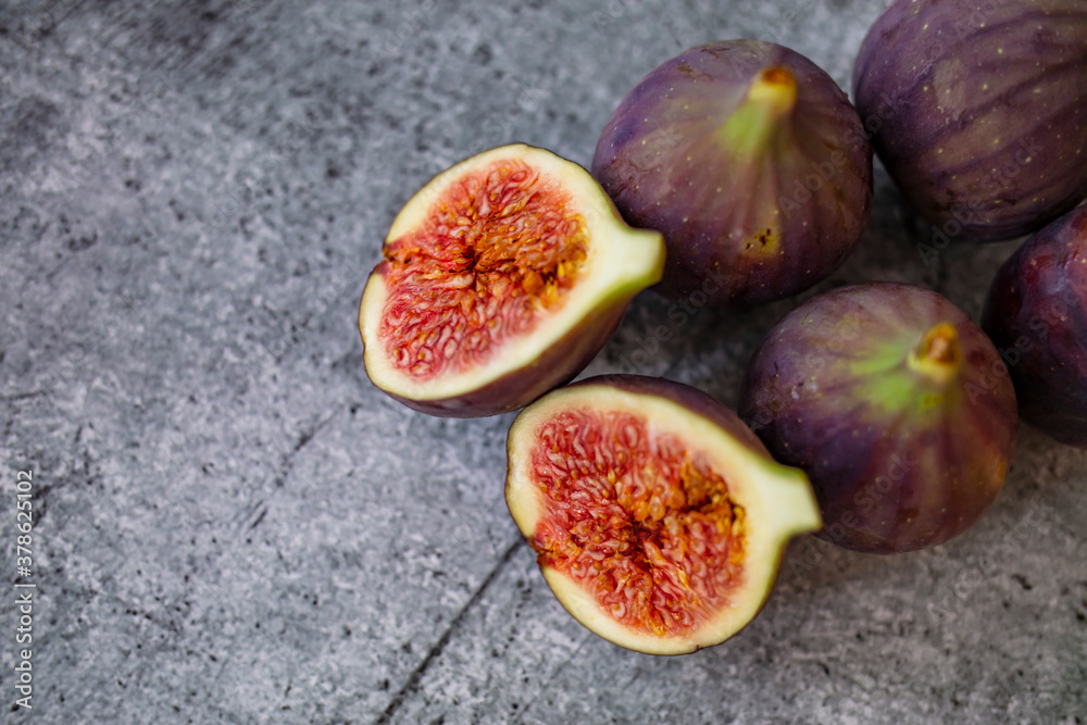 Fresh figs. Food Photo. whole and sliced figs on beautiful rustic background. Fresh Organic Figs. Healthy Mediterranean fig fruit. Beautiful blue-violet figs with empty copy space close up. Fresh figs. Food Photo. whole and sliced figs on beautiful rustic background. Fresh Organic Figs. Healthy Mediterranean fig fruit. Beautiful blue-violet figs with empty copy space close up.
