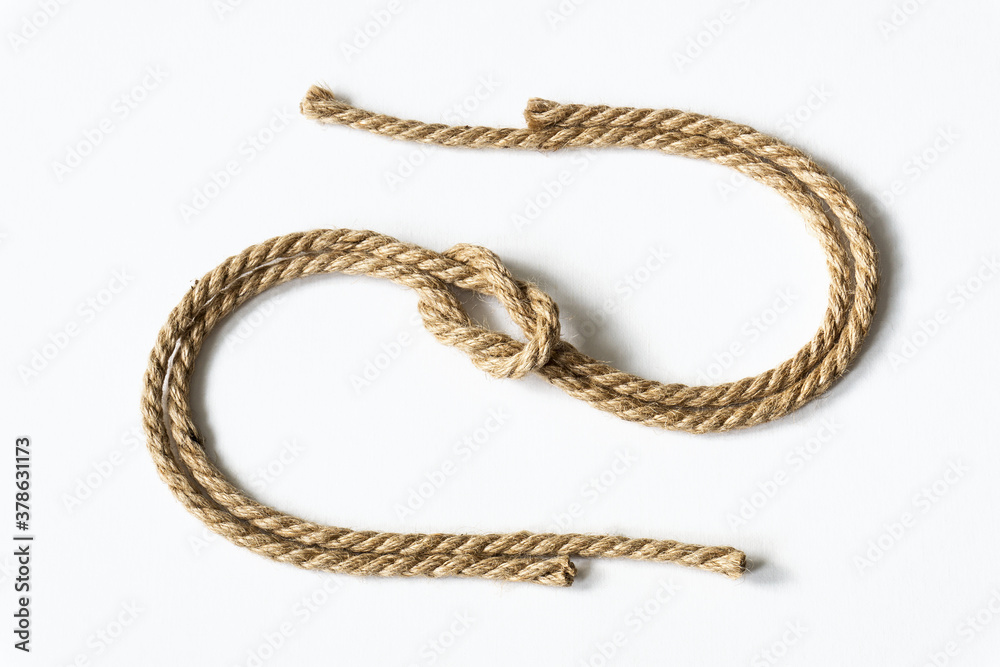 S-shaped jute rope with nautical knot on white background.