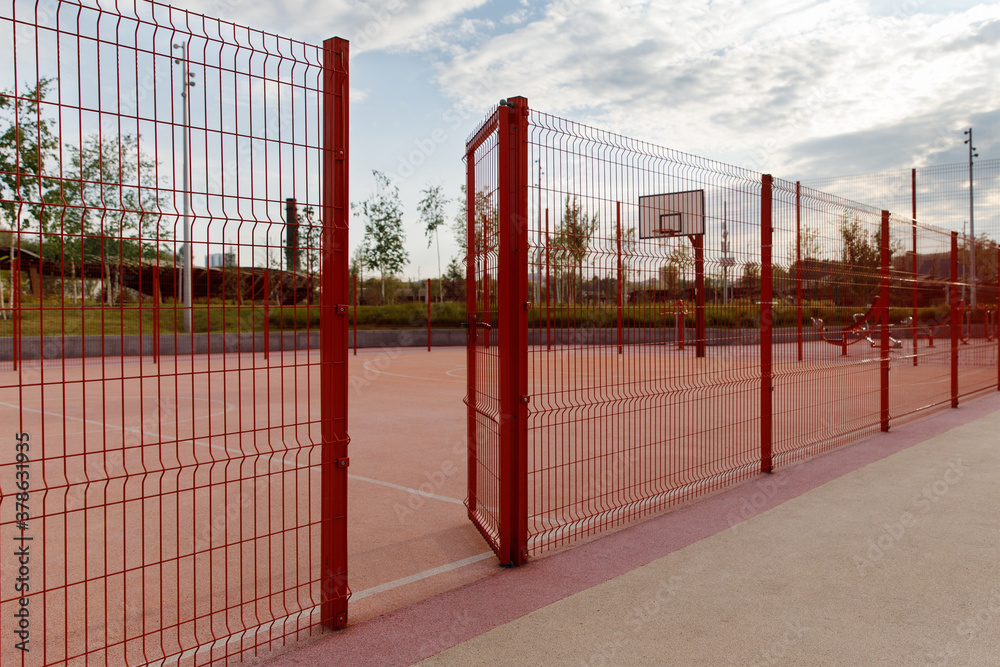 Entrance to the basketball court, outdoor sports ground, park, trees, sky.