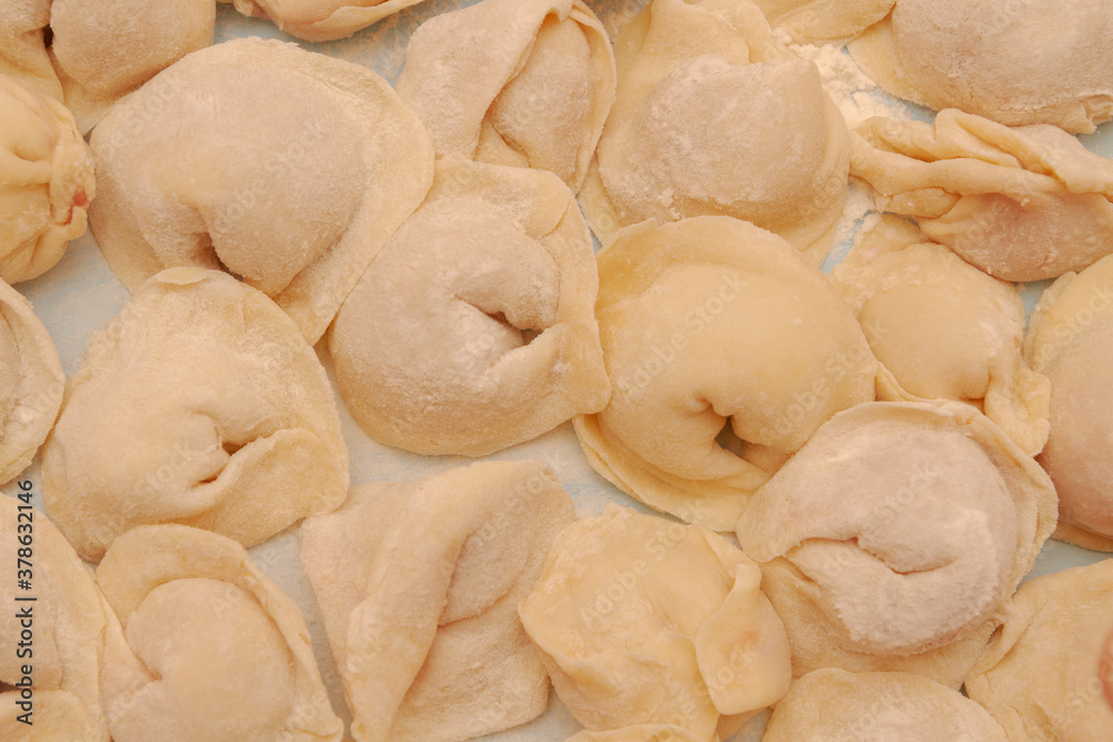 Homemade dumplings are put together on a Board in the kitchen Homemade dumplings are put together on a Board in the kitchen