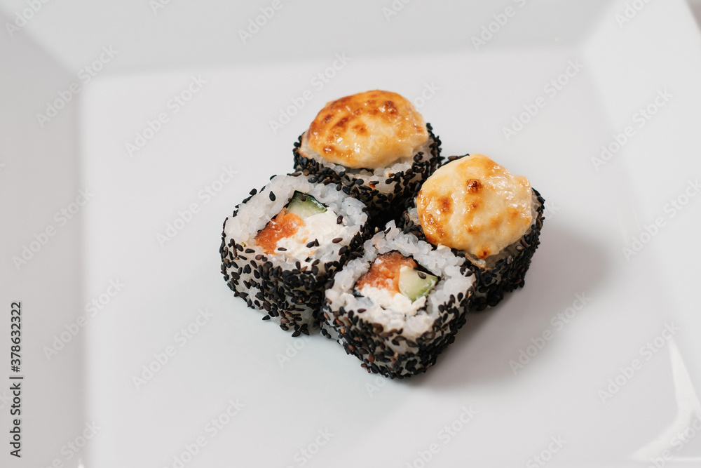 Top view of assorted sushi rolls on white plate. Top view of assorted sushi rolls on white plate.