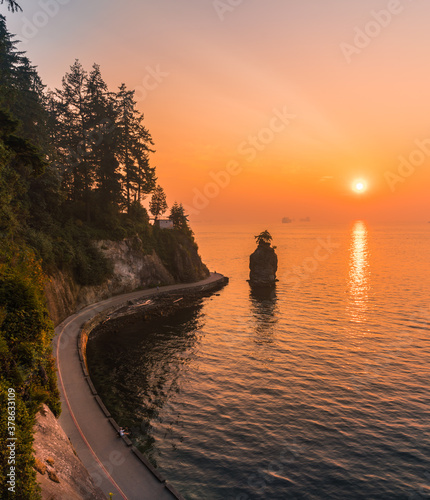 sea wall Stanley park with sunset over the sea backgrounds photo